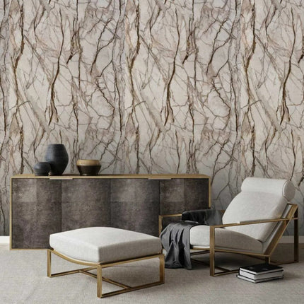 Modern living room with a console table, chair, and ottoman against a antique marble patterned wall panel.