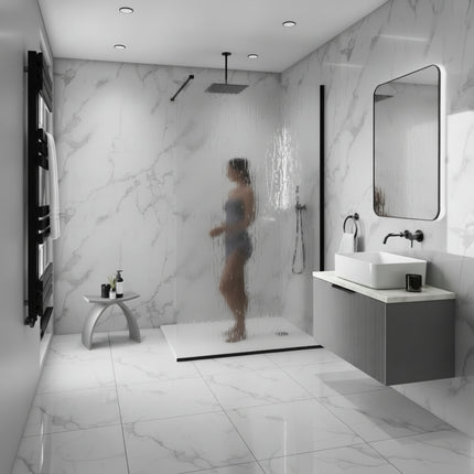 Modern bathroom with marble walls, a shower, and sink.