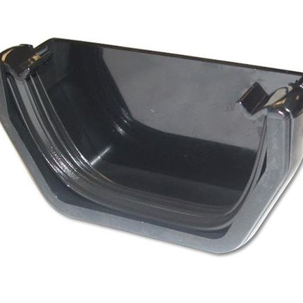 Black plastic guttering external stop end on a white background