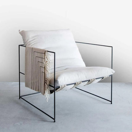 Gloss White Wall Panel Maxi Panel behind a Modern chair with a white cushion and a beige blanket on a light gray floor.