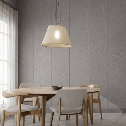 Dining area with wooden table and chairs against a gray panel wall.