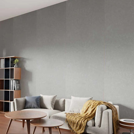 Pewter Stone Maxi Panel Wall Panels in a living room with a sofa, coffee table, and bookshelf.